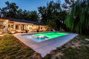 View of pool featuring a patio and a lawn