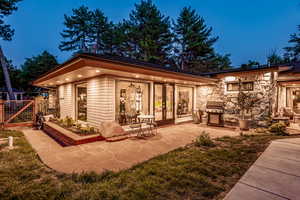 Back house at dusk with a patio area