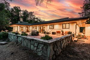 Back house at dusk with a patio area