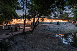 Yard at dusk with a patio area