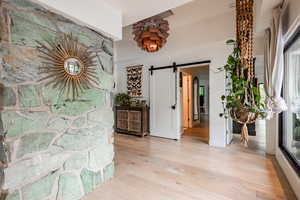 Foyer featuring a barn door and light wood-type flooring