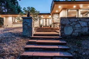 Exterior entry at dusk featuring french doors