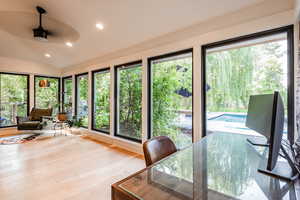 Sunroom featuring plenty of natural light, lofted ceiling, and ceiling fan