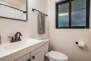 Bathroom featuring vanity and toilet