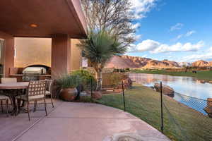 View of patio / terrace with a grill, exterior kitchen, and a water and mountain view