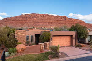 Adobe home with a garage and a mountain view