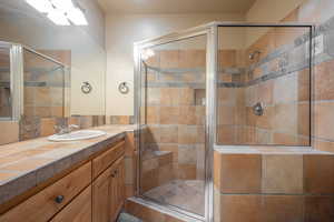 Bathroom with vanity and an enclosed shower