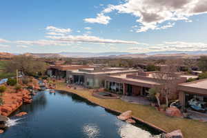 View of pool featuring a water and mountain view, a yard, and a patio area