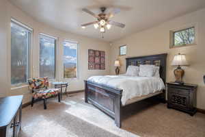 Carpeted bedroom featuring ceiling fan