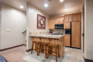 Kitchen with sink, a kitchen breakfast bar, and kitchen peninsula