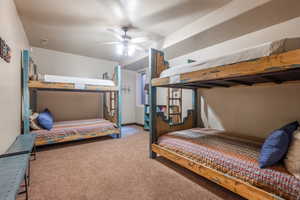 Bedroom with ceiling fan and carpet