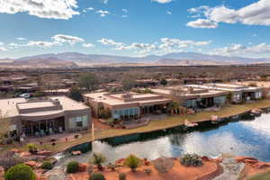 Birds eye view of property with a water and mountain view