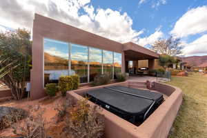 View of patio / terrace featuring a covered hot tub and a mountain view