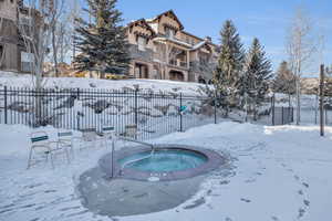 Snow covered pool with a community hot tub