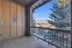 View of snow covered back of property