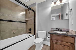 Full bathroom with vanity, toilet, and combined bath / shower with glass door