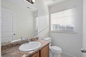 Bathroom featuring vanity and toilet