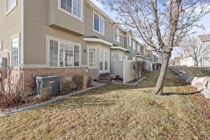 Exterior space with a lawn and central air condition unit