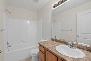 Full bathroom with shower / tub combination, vanity, toilet, and tile patterned flooring