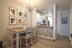 Dining area featuring an inviting chandelier and light hardwood / wood-style floors