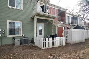 Exterior space with central AC and a balcony