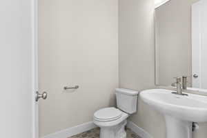 Bathroom featuring sink and toilet