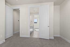 Unfurnished bedroom featuring light colored carpet