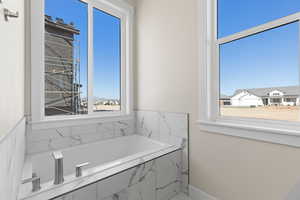 Bathroom with tiled bath