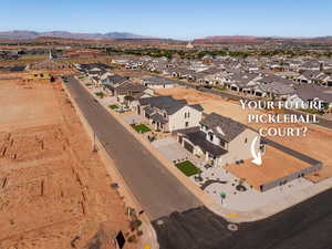 Aerial view of property and surrounding area with nearby suburban area and a mountainous background
