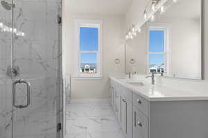 Bathroom featuring vanity and an enclosed shower