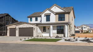 View of front facade with a garage and a porch