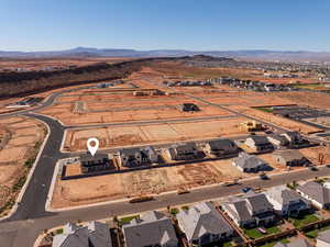 Aerial view of property and surrounding area featuring nearby suburban area