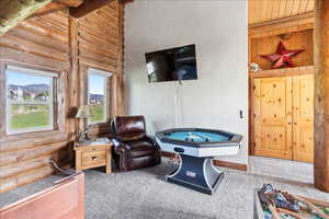 Playroom with vaulted ceiling, wooden ceiling, rustic walls, and carpet