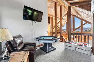 Game room with lofted ceiling with beams, carpet flooring, and wood ceiling