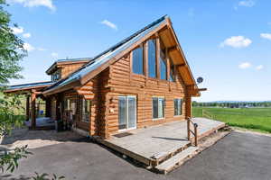 View of home's exterior with central AC unit, a deck, and a rural view