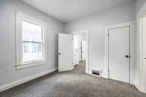 Unfurnished bedroom with carpet