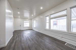 Unfurnished room with dark wood-type flooring