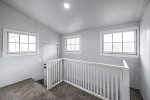 Interior space featuring lofted ceiling and carpet floors