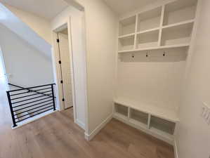 Mudroom with light hardwood / wood-style flooring