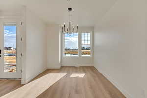 Dining area featuring light hardwood / wood-style floors and a chandelier