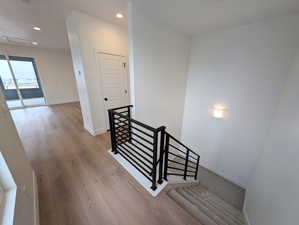 Staircase featuring hardwood / wood-style flooring