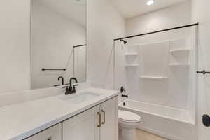 Full bathroom featuring vanity, tile flooring, toilet, and  shower combination