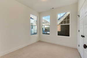 Upper secondary bedroom featuring light carpet