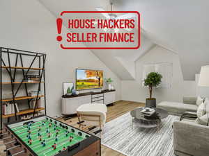 Recreation room featuring lofted ceiling and wood finished floors
