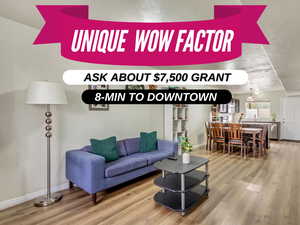 Living area featuring a textured ceiling, baseboards, and wood finished floors