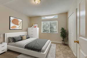 Carpeted bedroom with a closet and baseboards