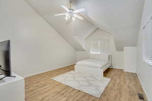 Sitting room featuring a healthy amount of sunlight, ceiling fan, lofted ceiling, and light wood-type flooring