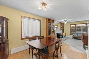 Dining space with light parquet floors and ceiling fan