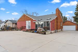 View of front of property featuring a garage and an outdoor structure