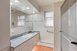 Bathroom with vanity and baseboard heating